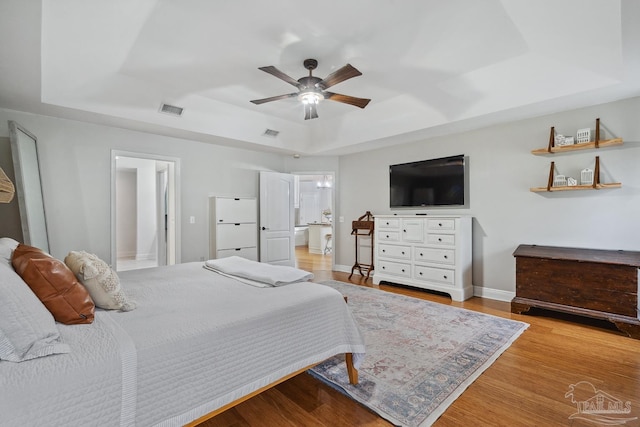 1333 Dubose Rd, Gulf Breeze, FL 32563 - bedroom featuring a raised ceiling, wood finished floors, baseboards, and ceiling fan