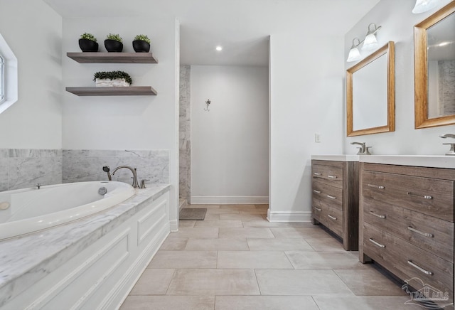 1333 Dubose Rd, Gulf Breeze, FL 32563 - bathroom featuring vanity, a garden tub, walk in shower, baseboards, and tile patterned floors