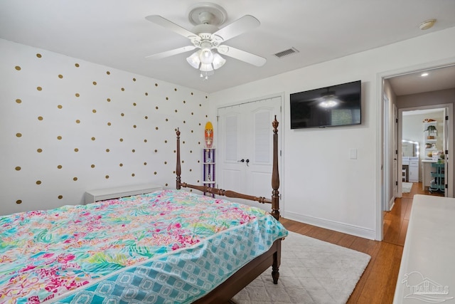 1333 Dubose Rd, Gulf Breeze, FL 32563 - bedroom featuring light wood-style flooring, a ceiling fan, wallpapered walls, and baseboards
