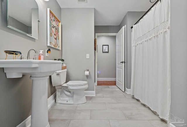 1333 Dubose Rd, Gulf Breeze, FL 32563 - full bath with toilet, baseboards, tile patterned floors, and a shower with shower curtain