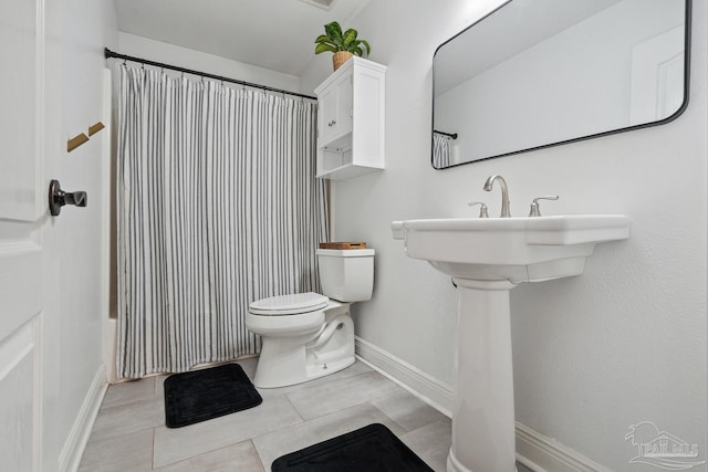 1333 Dubose Rd, Gulf Breeze, FL 32563 - bathroom featuring toilet, baseboards, and tile patterned flooring