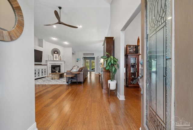 1333 Dubose Rd, Gulf Breeze, FL 32563 - entryway featuring ceiling fan, wood finished floors, a fireplace with raised hearth, baseboards, and high vaulted ceiling