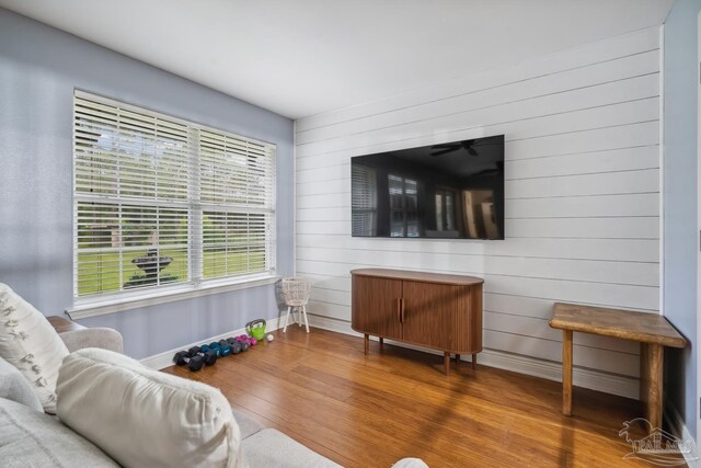 1333 Dubose Rd, Gulf Breeze, FL 32563 - living room with baseboards, wood finished floors, and wooden walls