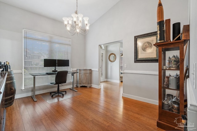 1333 Dubose Rd, Gulf Breeze, FL 32563 - home office with a chandelier, light wood-style flooring, high vaulted ceiling, and baseboards