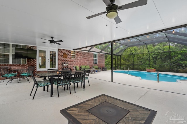 1333 Dubose Rd, Gulf Breeze, FL 32563 - swimming pool featuring a ceiling fan, a patio area, outdoor dining area, and glass enclosure
