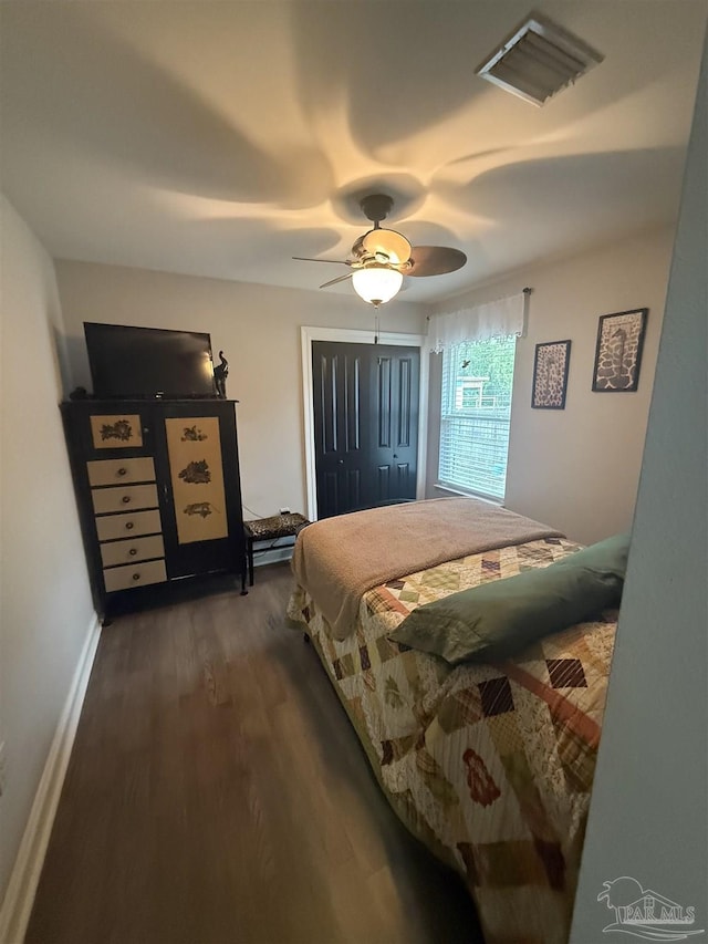 5407 Maverick Ln, Gulf Breeze, FL 32563 - bedroom with visible vents, a closet, baseboards, ceiling fan, and dark wood-type flooring