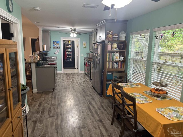 5407 Maverick Ln, Gulf Breeze, FL 32563 - dining room featuring ceiling fan, baseboards, dark wood finished floors, and visible vents