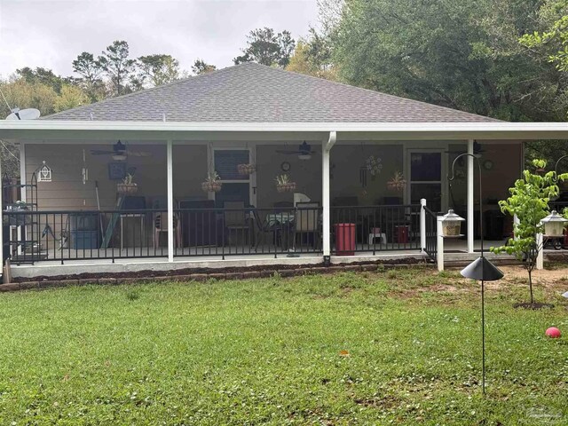 5407 Maverick Ln, Gulf Breeze, FL 32563 - back of property featuring a yard, a shingled roof, and ceiling fan