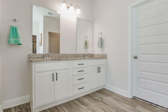 bathroom with hardwood / wood-style floors and vanity