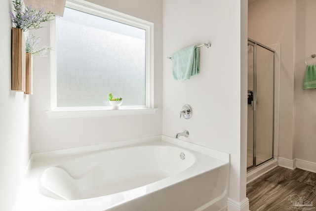 bathroom with plus walk in shower and wood-type flooring