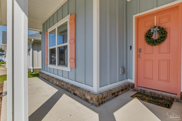 view of exterior entry with a porch