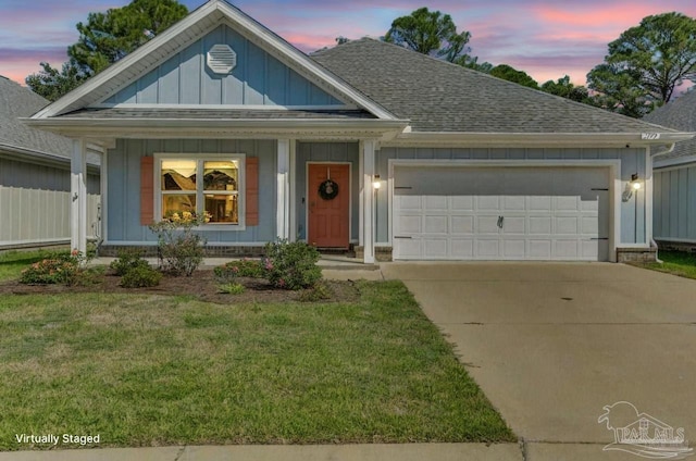 view of front of property with a lawn and a garage