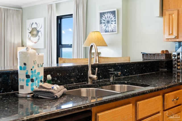 kitchen with dark stone countertops and sink