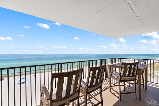 balcony with a water view and a beach view