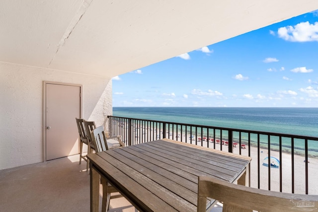 balcony with a beach view and a water view