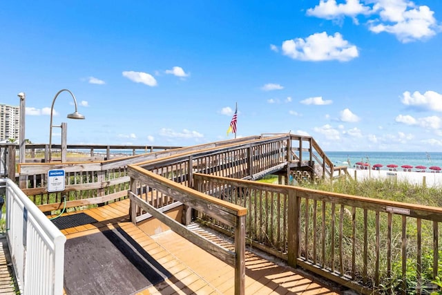 view of community featuring a beach view and a water view