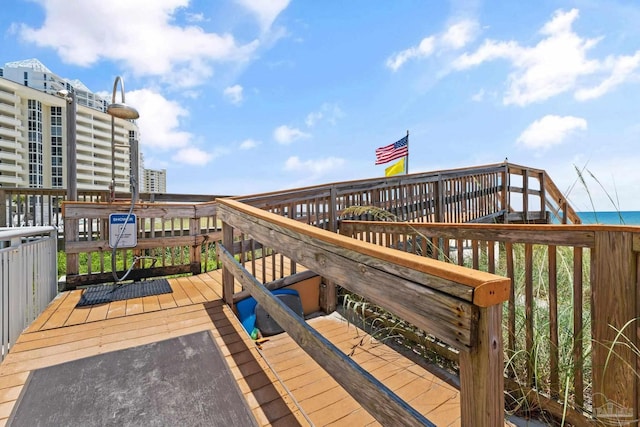 surrounding community with a deck with water view