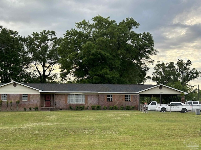 single story home featuring a carport and a front yard