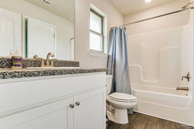 full bathroom with vanity, hardwood / wood-style flooring, toilet, and shower / bath combo with shower curtain