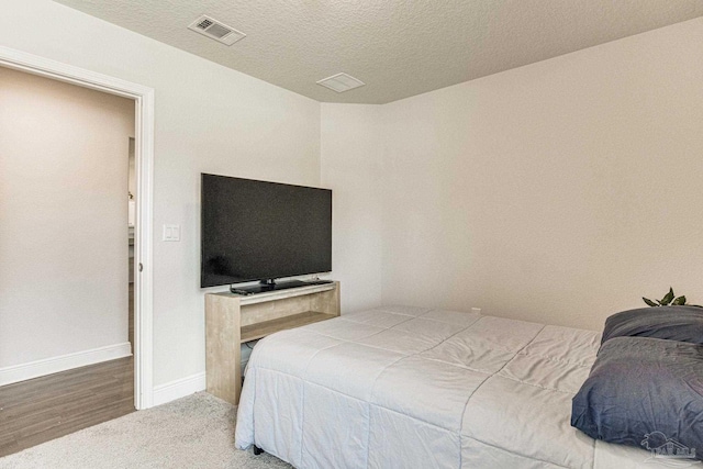 carpeted bedroom with a textured ceiling