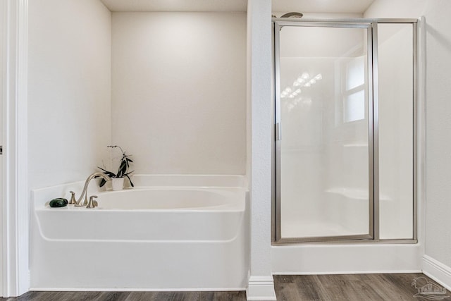 bathroom with separate shower and tub and hardwood / wood-style floors