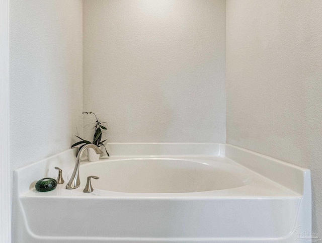 bathroom with a tub to relax in