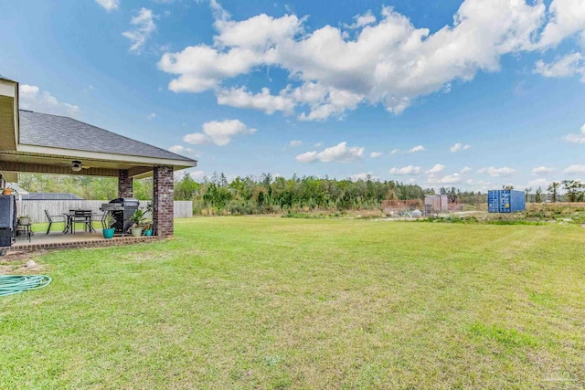 view of yard featuring a patio area and ceiling fan