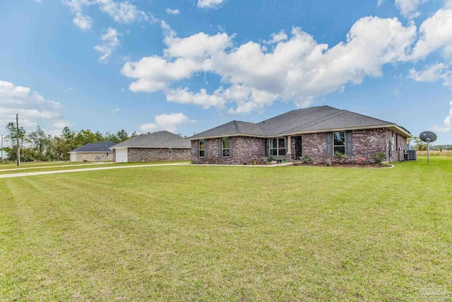 view of front of property with central AC and a front lawn