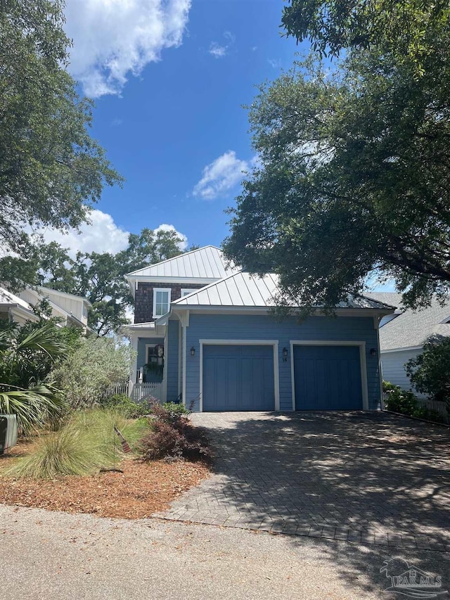 16 Duncan Ave, Gulf Breeze, FL 32561 - view of front facade with a standing seam roof, decorative driveway, metal roof, and an attached garage