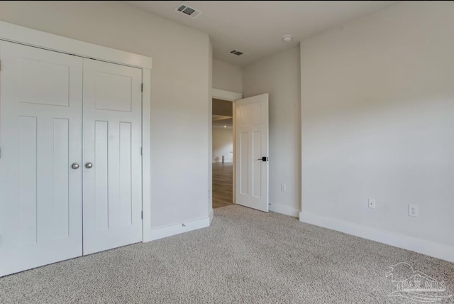 unfurnished bedroom with baseboards, visible vents, and carpet floors