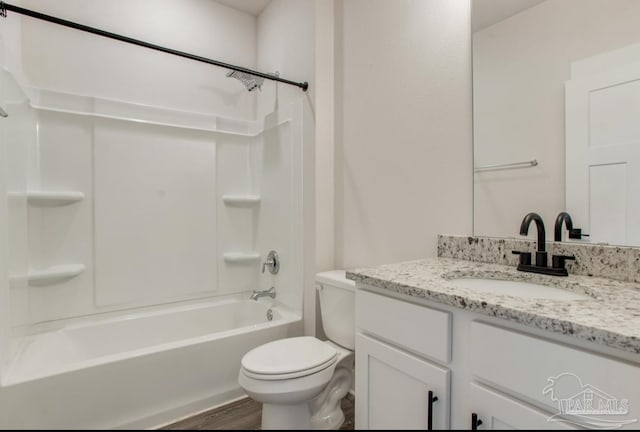 bathroom featuring washtub / shower combination, wood finished floors, toilet, and vanity