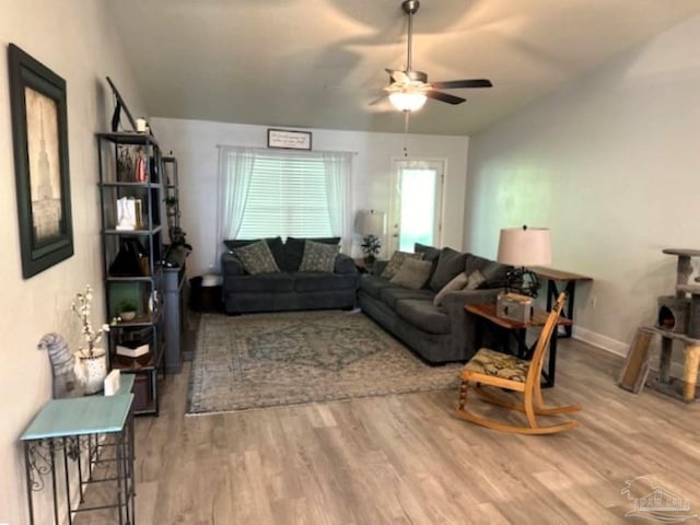 living room with ceiling fan and wood-type flooring