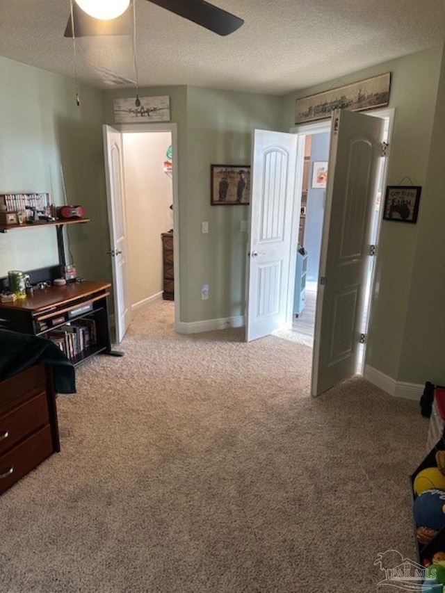 bedroom with light carpet, a textured ceiling, and ceiling fan