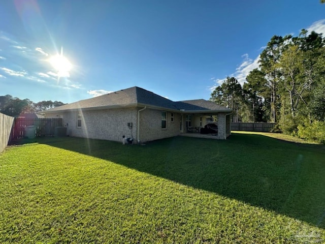 rear view of property featuring a yard