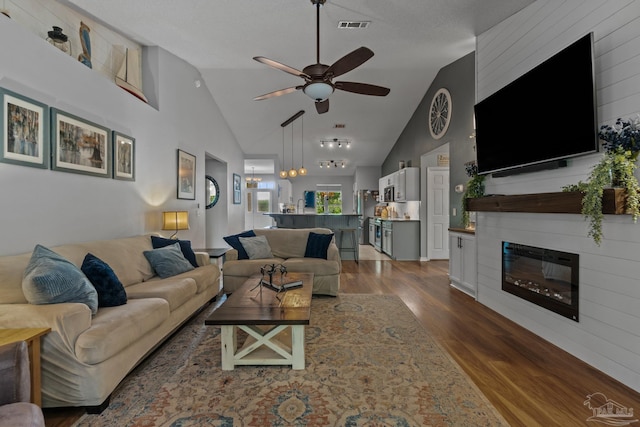 1265 Grand Ridge Cir, Gulf Breeze, FL 32563 - living area with dark wood-style floors, ceiling fan, high vaulted ceiling, and a large fireplace