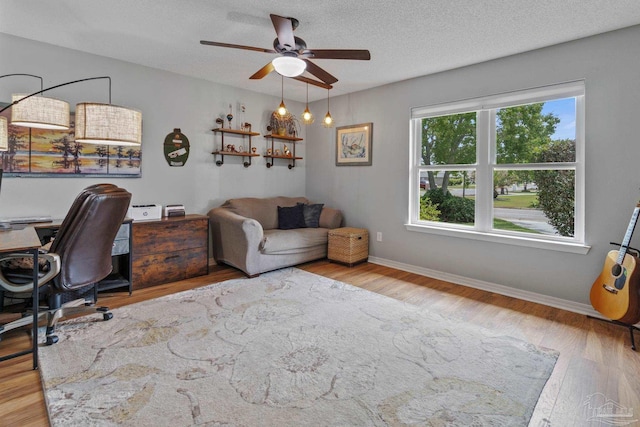 1265 Grand Ridge Cir, Gulf Breeze, FL 32563 - office with wood finished floors, ceiling fan, a textured ceiling, and baseboards