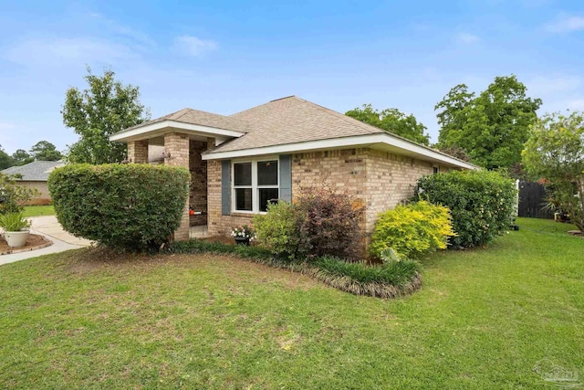1265 Grand Ridge Cir, Gulf Breeze, FL 32563 - view of property exterior featuring brick siding, a yard, and roof with shingles