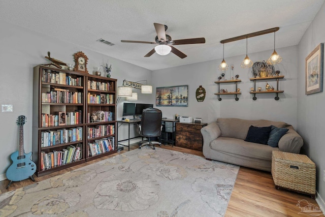 1265 Grand Ridge Cir, Gulf Breeze, FL 32563 - office area with a ceiling fan, wood finished floors, and a textured ceiling