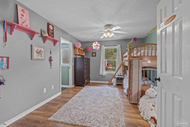 1265 Grand Ridge Cir, Gulf Breeze, FL 32563 - bedroom with baseboards, wood finished floors, and a textured ceiling