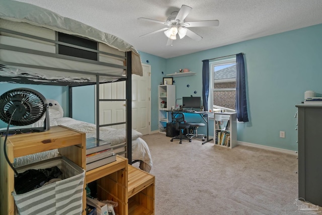 1265 Grand Ridge Cir, Gulf Breeze, FL 32563 - bedroom with a desk, a textured ceiling, carpet, baseboards, and ceiling fan
