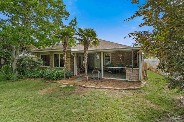 1265 Grand Ridge Cir, Gulf Breeze, FL 32563 - rear view of house featuring roof with shingles, brick siding, and a patio