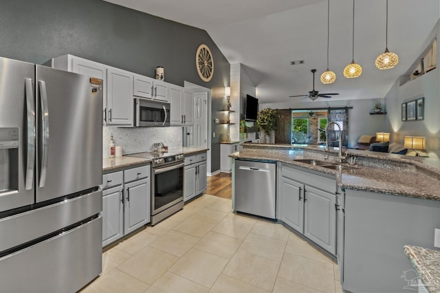 1265 Grand Ridge Cir, Gulf Breeze, FL 32563 - kitchen with appliances with stainless steel finishes, a sink, a ceiling fan, open floor plan, and vaulted ceiling