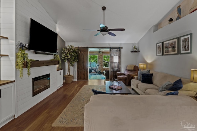 1265 Grand Ridge Cir, Gulf Breeze, FL 32563 - living area featuring vaulted ceiling, a ceiling fan, dark wood finished floors, and a glass covered fireplace