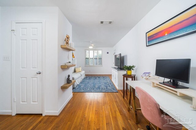 living room with ceiling fan and light hardwood / wood-style floors