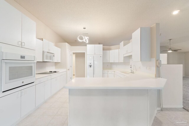 kitchen with white cabinets, white appliances, hanging light fixtures, and ceiling fan