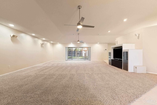 unfurnished living room featuring light colored carpet and ceiling fan