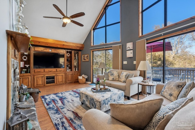living room featuring wood finished floors, high vaulted ceiling, and ceiling fan