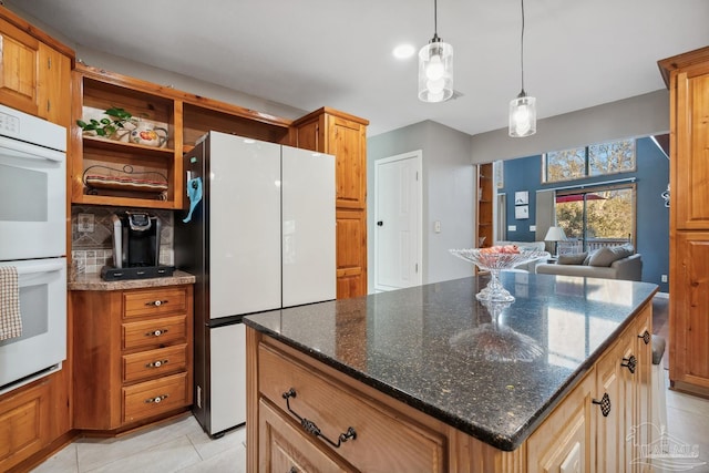 kitchen featuring tasteful backsplash, open shelves, white appliances, light tile patterned floors, and dark stone counters