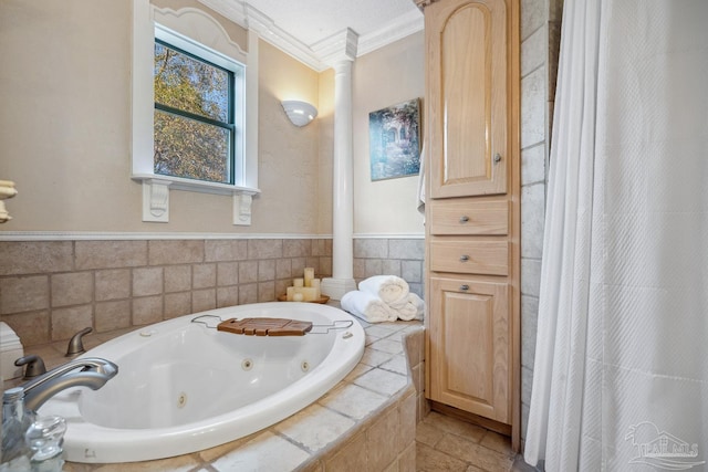 bathroom featuring a whirlpool tub, crown molding, and ornate columns