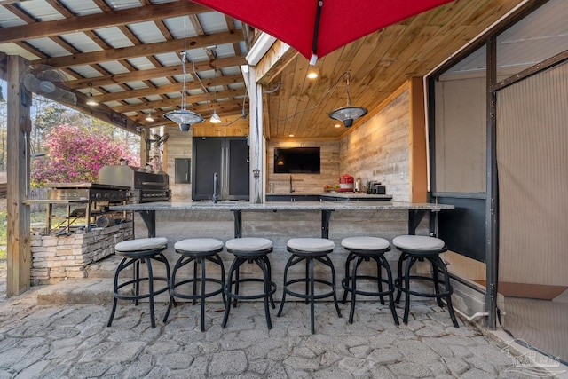 view of patio featuring an outdoor kitchen, outdoor wet bar, and a grill